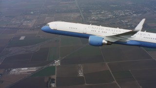 4K stock footage aerial video reveal a Boeing C-32 flying over farmland in Northern California Aerial Stock Footage | WAAF08_C018_0119DD