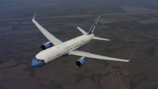 WAAF08_C028_0119NR - 4K stock footage aerial video a reverse view of a Boeing C-32 flying over farms and marshes in Northern California