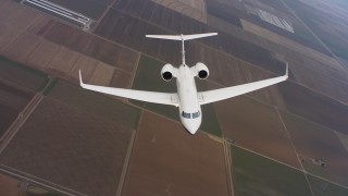 WAAF08_C045_0120SP - 4K stock footage aerial video of a reverse view of a Gulfstream C-37A flying over farmland in Northern California