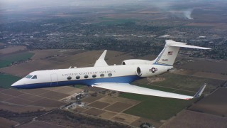 WAAF08_C057_0120EN_S000 - 4K stock footage aerial video of a Gulfstream C-37A in flight above farms in Northern California